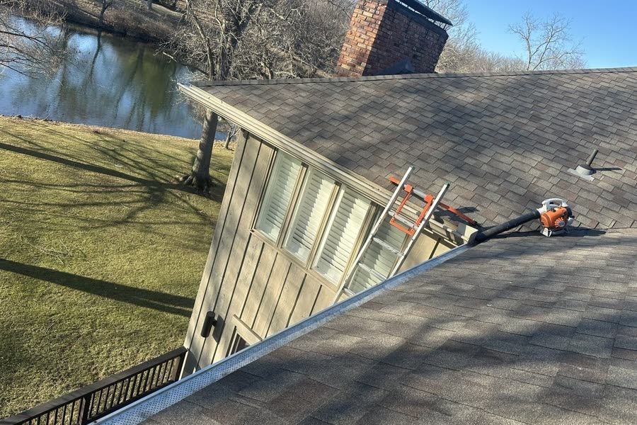 Leaf blower and tools on a roof during gutter clearing in Springfield Missouri